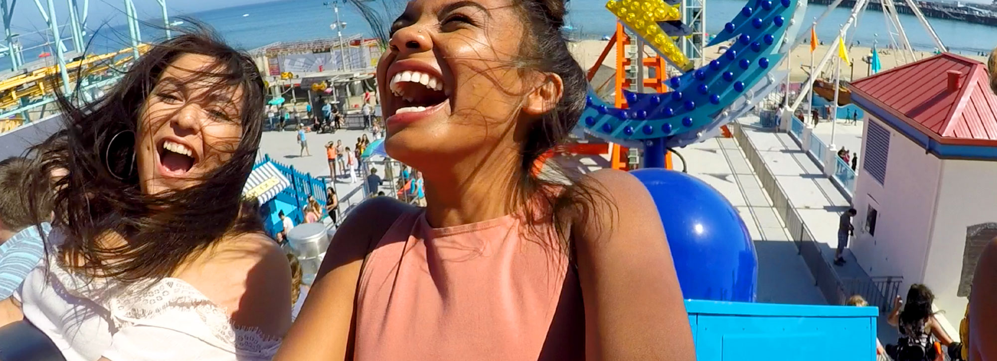 women riding a rollercoaster