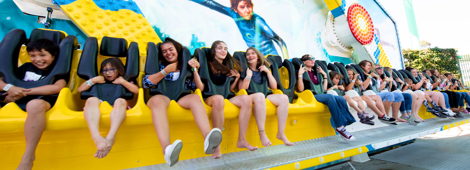 kids getting ready to ride a rollercoaster