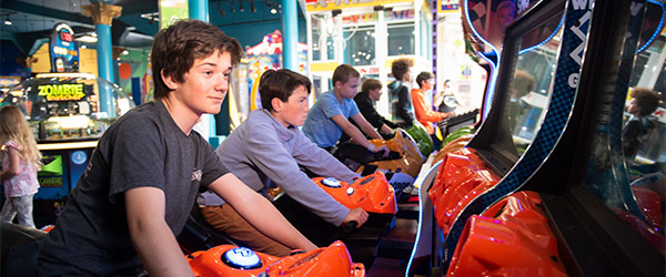 boys playing at arcade